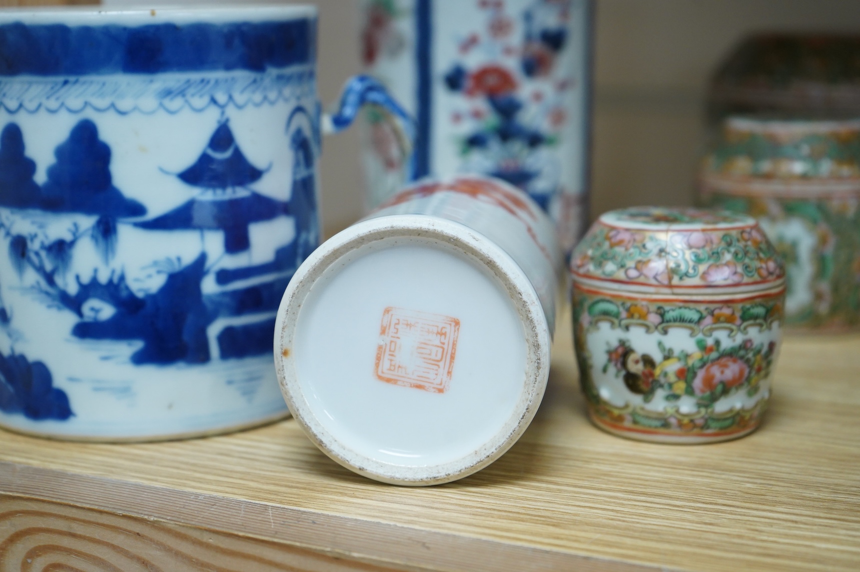 A collection of Chinese ceramics to include a blue and white mug, set of three graduated Canton jars and covers and two cylindrical brush washers